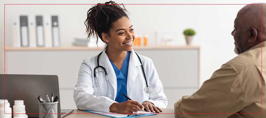 Primary care provider meeting with a patient at her desk for a same-day sick visit in Henderson NV