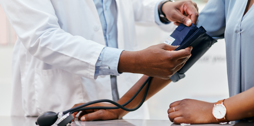 Provider measuring a patient's blood pressure as part of chronic disease management in Henderson NV