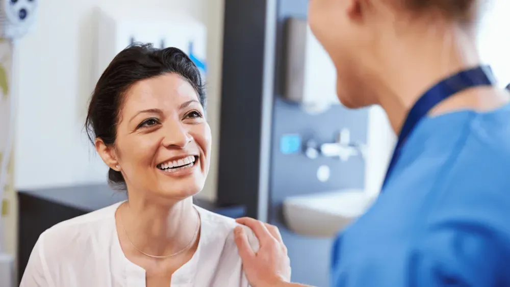 Welcoming primary care visit at a Henderson NV clinic, patient smiling with their provider