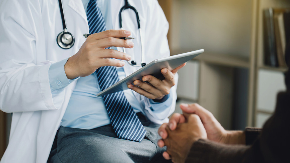 Henderson NV primary care provider reviewing patient records and care plan on a tablet